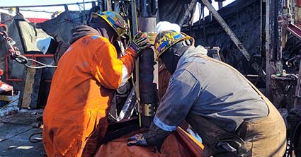 two field workers installing cable